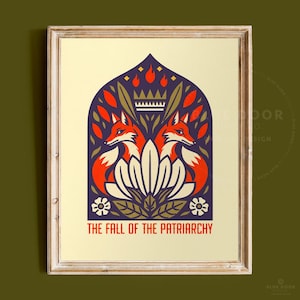 May include: A framed art print featuring a symmetrical illustration of two orange foxes facing outward, centered beneath a crown and flame motif. The design includes stylized leaves and flowers in a dark purple arch, with the text THE FALL OF THE PATRIARCHY.