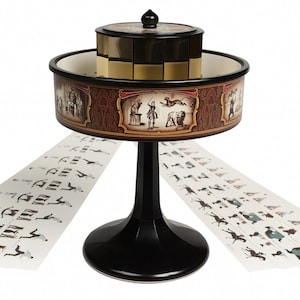 May include: A vintage zoetrope, a pre-film animation device, features a rotating drum with viewing slits. The base is black, supporting a circular drum with illustrations. Strips of sequential images are placed around the base.