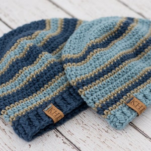 May include: Two blue and tan striped crocheted hats with leather labels that say "KHL".