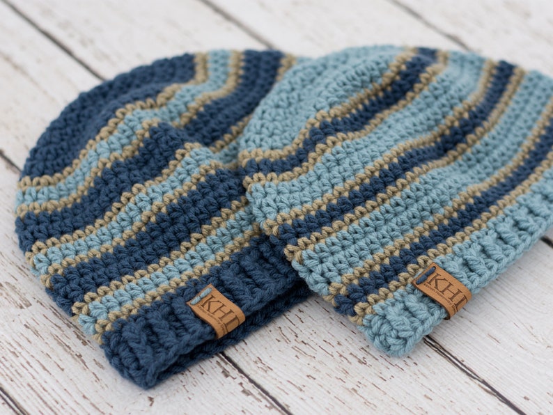 May include: Two blue and tan striped crocheted hats with leather labels that say "KHL".