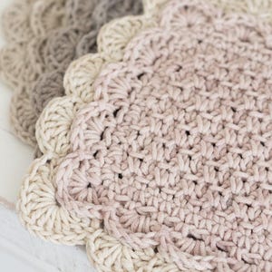 Up close view of scalloped crocheted mug rug.