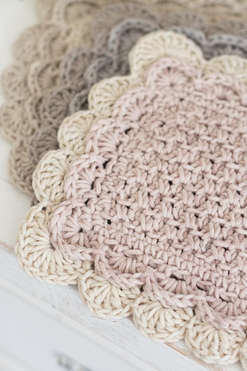 Up close view of scalloped crocheted mug rug.