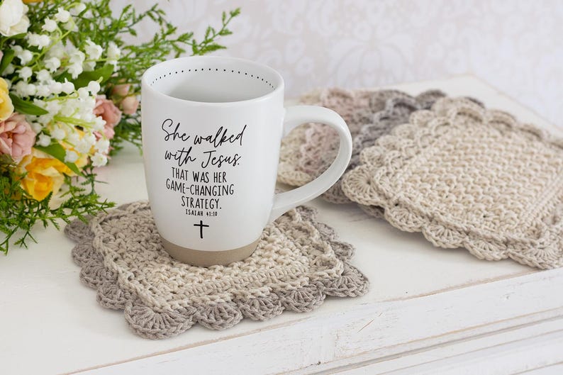 Scallop crochet mug rug with coffee cup and flowers.