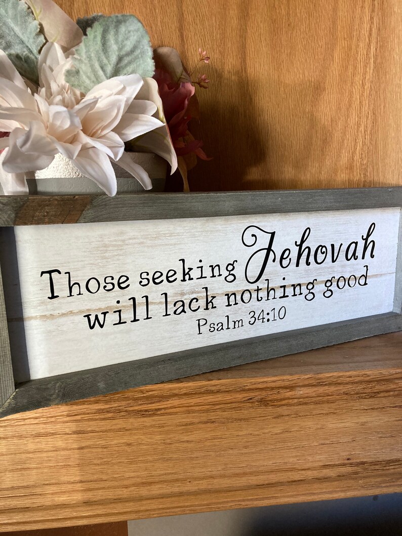 May include: A framed wood sign with a white background and black text. The text reads "Those seeking Jehovah will lack nothing good. Psalm 34:10".