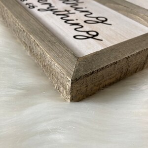 May include: A rustic wooden sign with a white background and black text that reads "Be thankful for everything and pray about nothing".