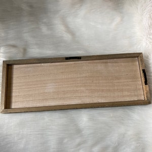 May include: A wooden rectangular sign with a light brown wood frame and a natural wood surface.