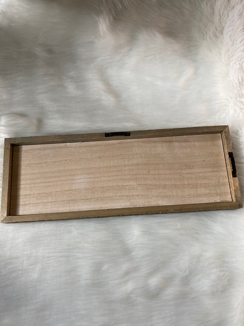 May include: A wooden rectangular sign with a light brown wood frame and a natural wood surface.