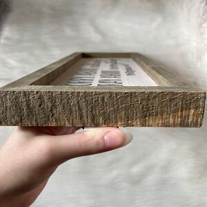 May include: A wooden sign with the text "Our family is a circle of strength and love. With every beat of our hearts, we are connected. Together we stand, together we grow, together we love."