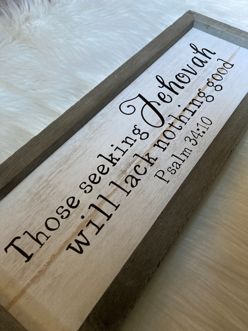 May include: A wooden sign with a gray frame and white background. The sign reads "Those seeking Jehovah will lack nothing good Psalm 34:10".