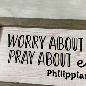 May include: A wooden sign with the text "Worry about nothing, pray about everything" and the scripture reference "Philippians 4:6".