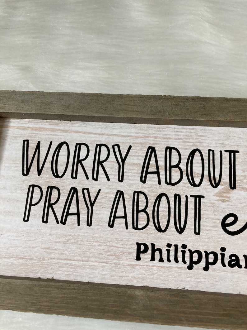 May include: A wooden sign with the text "Worry about nothing, pray about everything" and the scripture reference "Philippians 4:6".