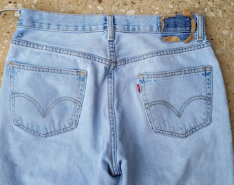 May include: A pair of light blue denim jeans with back pockets and a Levi's red tab.