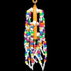 May include: A colorful beaded bird toy with a wooden dowel and white string. The beads are in various colors, including pink, blue, green, orange, and yellow.