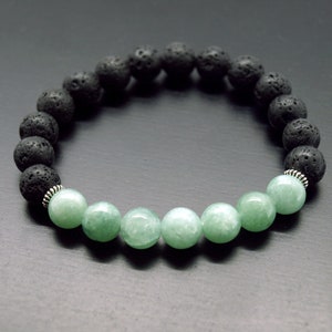 May include: A black lava rock and green jade beaded bracelet with silver spacers.