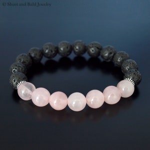 May include: A black lava rock and rose quartz beaded bracelet. The bracelet has a silver clasp.