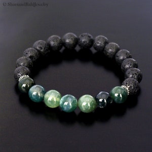 May include: A bracelet made with black lava rock beads and green agate beads. The bracelet has silver spacers between the beads.