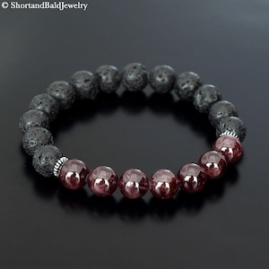 May include: A bracelet made of alternating dark grey lava rock beads and deep red garnet beads. The bracelet is strung on elastic and has a simple design. The jewellery is from ShortandBaldJewelry.