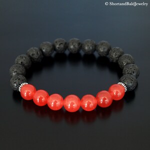 May include: A black lava rock and red gemstone bracelet. The bracelet is made with 8mm beads and has silver accents.