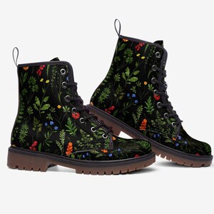 May include: Black lace-up boots with a floral pattern featuring green leaves, red berries, and blue and yellow flowers.