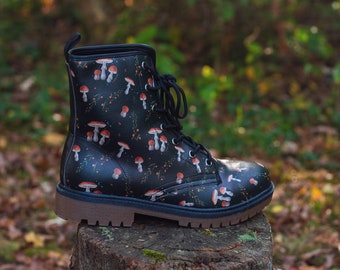 May include: Black leather ankle boots with a mushroom print. The boots have laces and a brown sole.