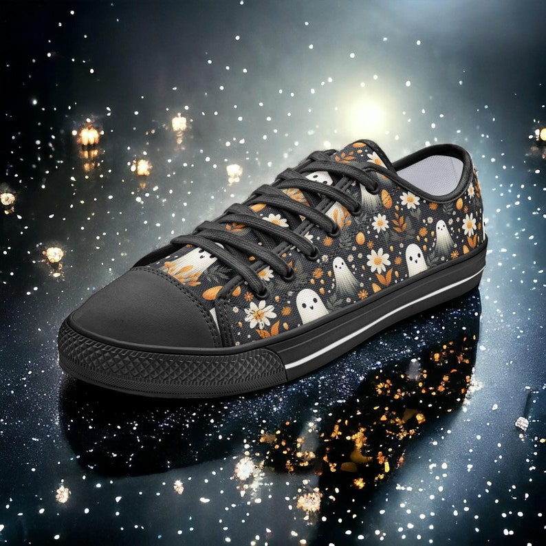 May include: Black canvas low-top sneakers with a white sole and a pattern of white ghosts and yellow flowers.