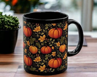 May include: Black coffee mug with a fall-themed design featuring orange pumpkins and yellow leaves on a black background.