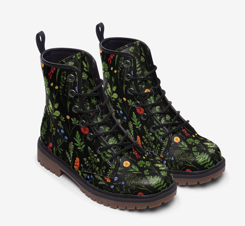 May include: Black leather ankle boots with a floral print featuring green leaves, red, yellow, and blue flowers. The boots have a lace-up closure and a chunky sole.