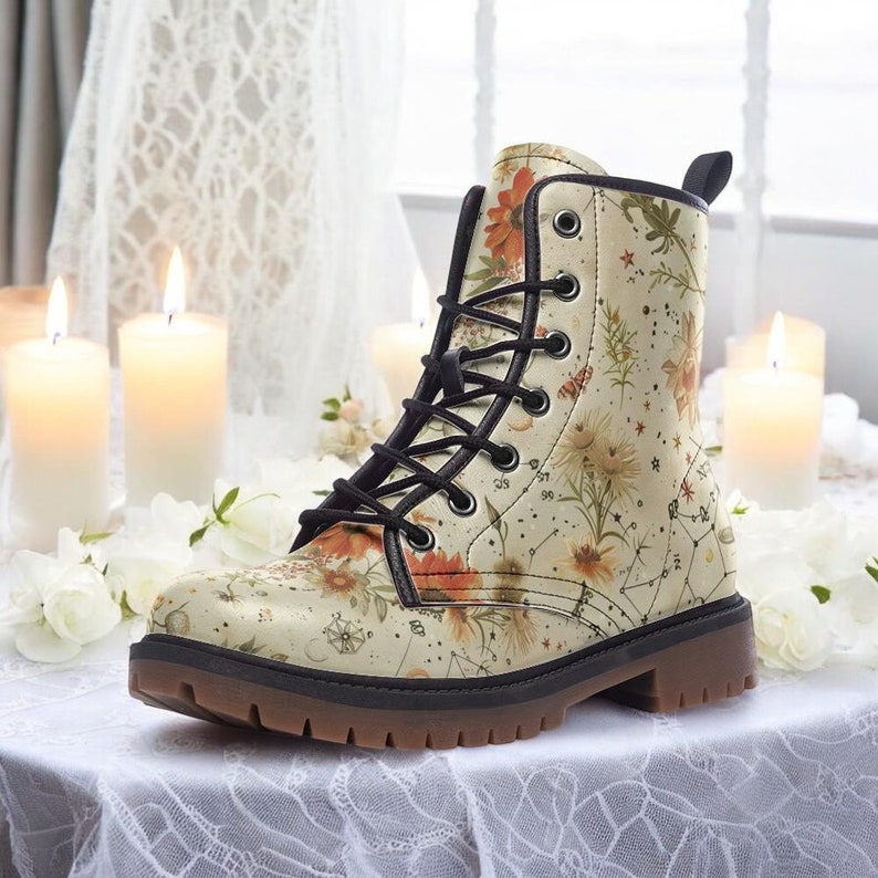 Pair of cream floral combat boots with a botanical print, styled with lace, roses, and candlelight for a soft cottagecore wedding feel.