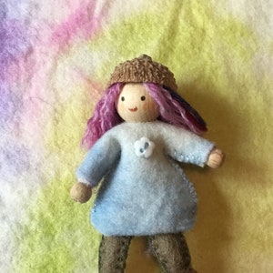 pixie bendy doll dressed with purple hair and an acorn hat