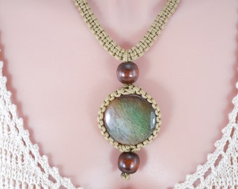 May include: A gold macrame necklace with a green and brown agate stone pendant and brown wooden beads.