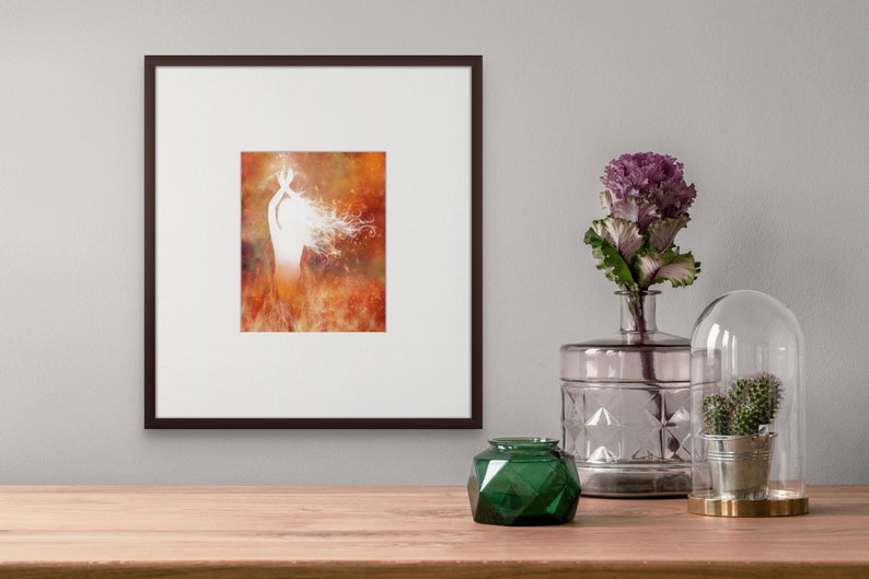 Framed print featuring illustration of a woman rising from flames