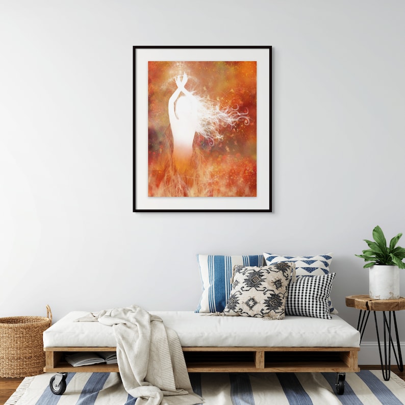 Framed print featuring illustration of a woman rising from flames