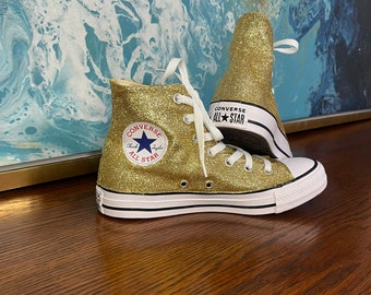 Gold Converse all stars.