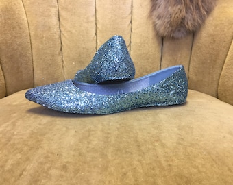 woman’s blue ballet flats. Pointed toe, light blue flats.