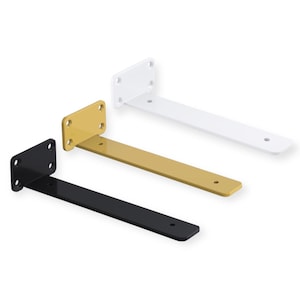May include: Three metal shelf brackets in black, gold, and white. Each bracket has a rectangular mounting plate with four holes and a long, flat arm with a single hole. The brackets are designed for supporting shelves.