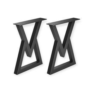 May include: Two black metal table legs with an X-shaped design. The legs have a flat top for attaching to a tabletop and are suitable for various furniture projects. The legs are made of sturdy metal and are painted black.