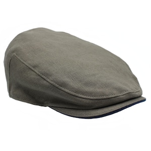 May include: An olive green flat cap with a rounded crown and a small, stiff brim. The brim is lined with dark blue fabric. The cap is made of a textured material. A classic style of headwear.