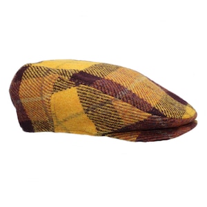 May include: A yellow and brown checked flat cap. The cap has a slightly curved brim and a soft, textured fabric.