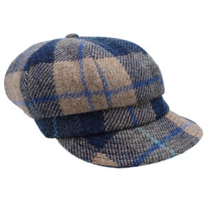 May include: A blue and brown checked newsboy cap with a curved brim.