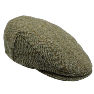 May include: A green and brown tweed flat cap. The cap features a classic design with a rounded crown and a small, stiff brim. The fabric has a herringbone pattern.