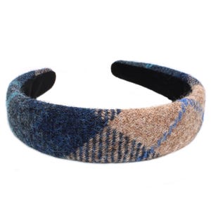 May include: A blue and brown plaid headband made of wool.