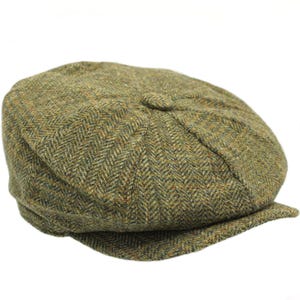 May include: A green and brown tweed newsboy cap with a herringbone pattern.