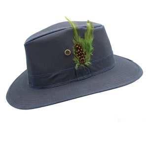 May include: A navy blue safari hat with a wide brim and a green and brown feather accent.