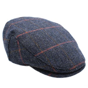 May include: A blue tweed flat cap with a plaid pattern in orange and yellow. The cap has a rounded crown and a short, stiff brim. The fabric has a herringbone weave.