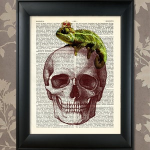 May include: A vintage book page with a red anatomical skull illustration and a green chameleon with a gold crown perched on top of the skull. The text on the page is in Greek.
