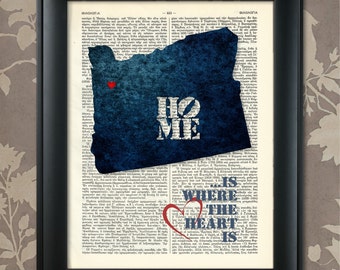May include: A blue and white print of the state of Oregon with the word "Home" and a red heart in the center. The text "Where the heart is" is printed below the state outline.