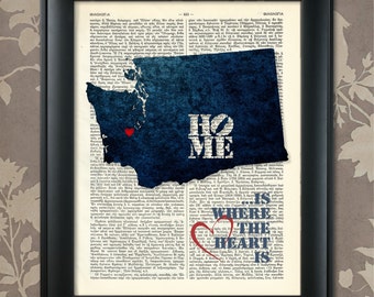 May include: A blue and white print of the state of Washington with the words "Home is where the heart is" and a red heart in the center. The print is on a vintage book page background.