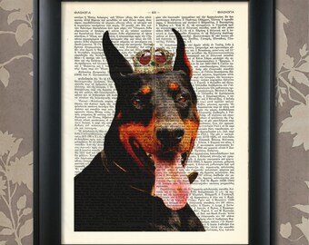 May include: Framed print featuring a Doberman Pinscher wearing a crown, set against a vintage dictionary page background. The dog is black and tan with its tongue out. The black frame complements the artwork.