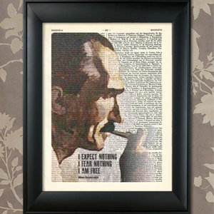 May include: A black and white image of Nikos Kazantzakis, a Greek writer, superimposed on a page of text from a book. The image is in a black frame. The text reads "I expect nothing, I fear nothing, I am free."  The quote is attributed to Nikos Kazantzakis.