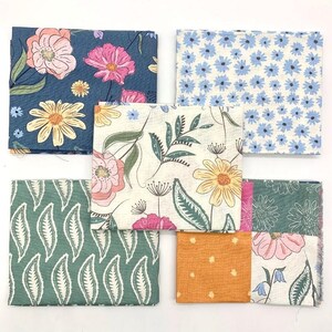 May include: Six fabric squares featuring floral patterns. The squares are in a variety of colours, including blue, green, white, and orange. The patterns include small blue flowers, large pink flowers, green leaves, and yellow flowers.
